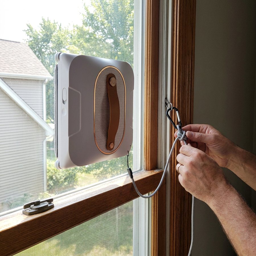 Securing the safety cord before the robot cleans an upstairs window